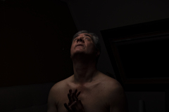 Fine art photograph of a man praying focused on light, composition, and a moment of stillness.