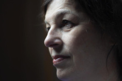 “Fine art portrait of strong woman in a minimal setting, focusing on stillness, light, and presence.”