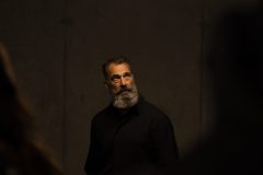 “Fine art portrait of man with grey breath in a minimal setting, focusing on stillness, light, and presence.”